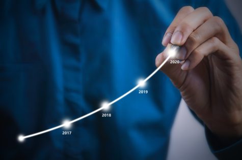 businessman-using-pen-drawing-graphics-line-year-growing-graph-describe-the-organizations-management_t20_GJ4Xv6