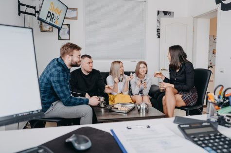 young-team-of-smm-pr-specialists-resting-m-communicating-during-lunch-break-in-their-modern-office_t20_XvxpKl